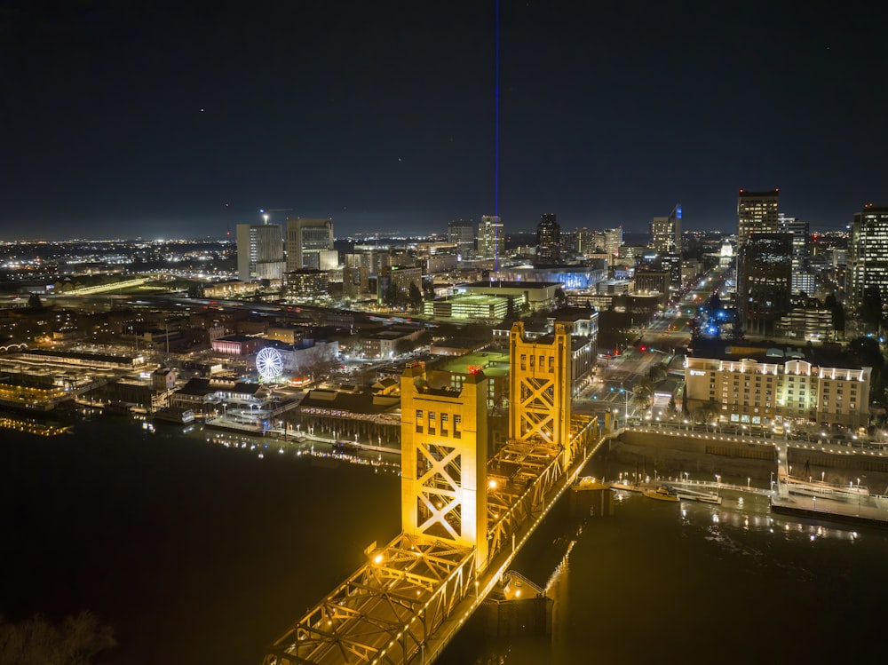 a view of a city at night from the top of a bridge