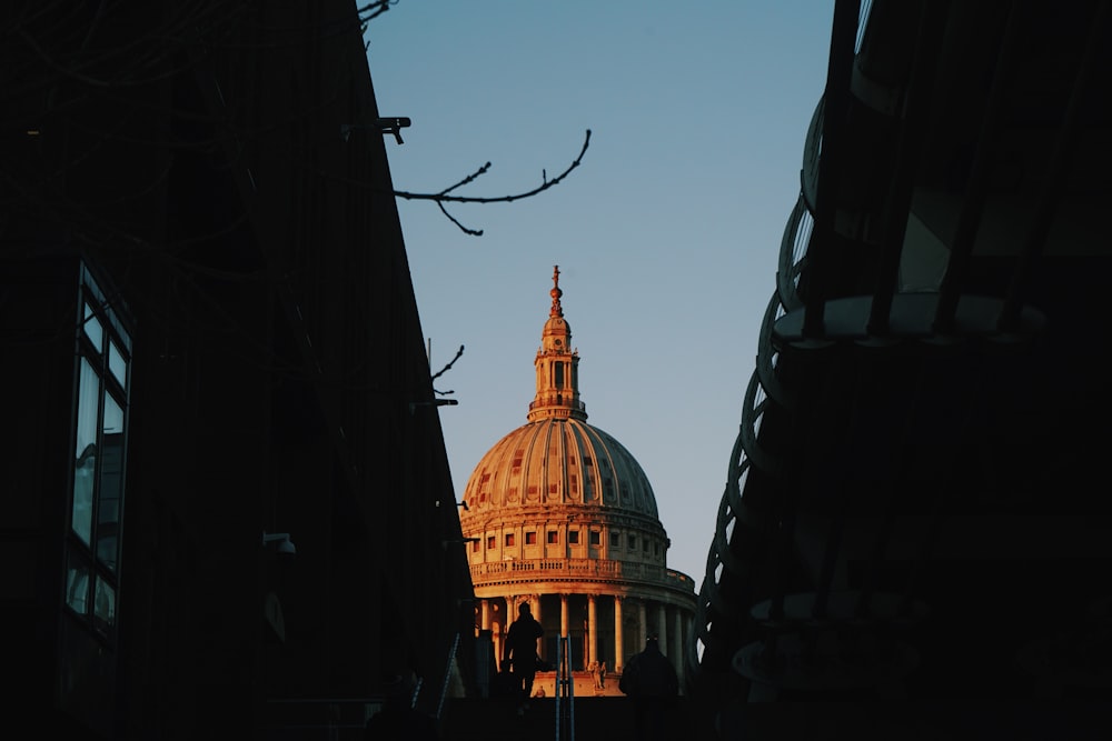 the dome of a building is seen through some buildings