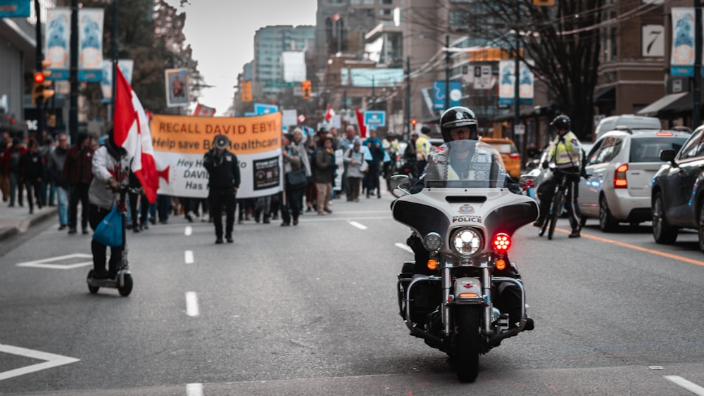 a police officer riding a motorcycle down a street