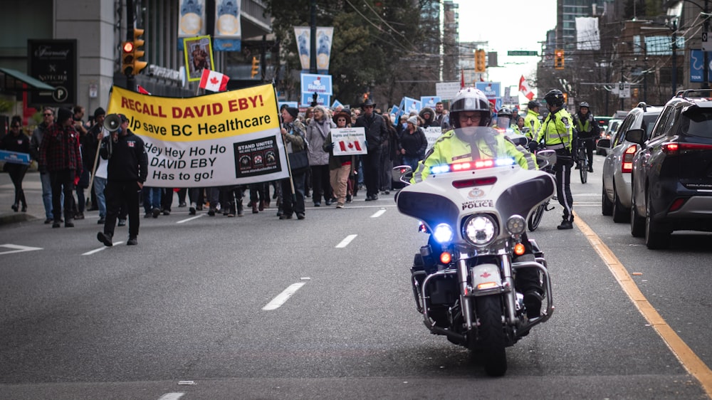 a police officer riding a motorcycle down a street