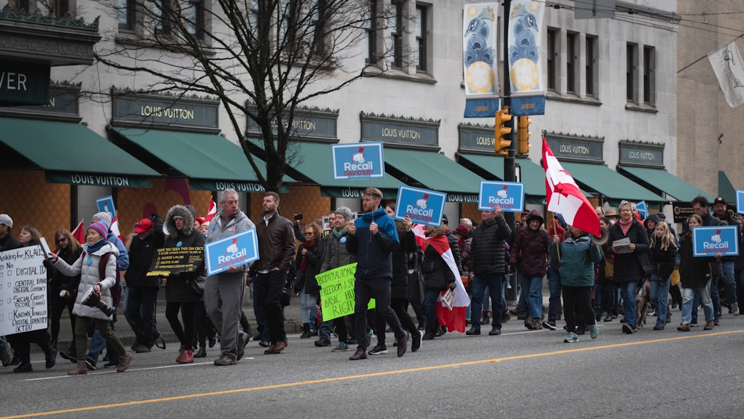 a group of people marching down a street holding signs