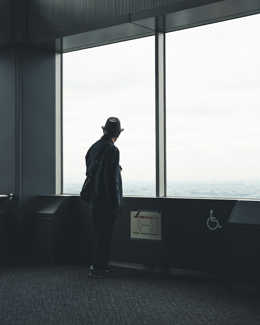 a man standing in front of a large window