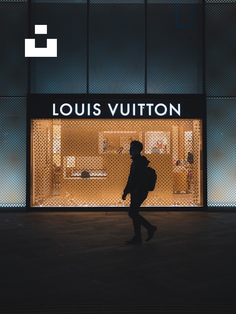 A person walking in front of a louis vuitton store photo – Free Street  photography Image on Unsplash