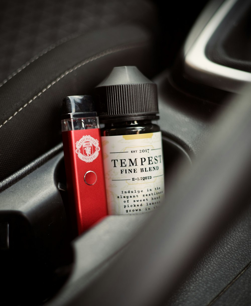 a bottle of tea sits in the center console of a car