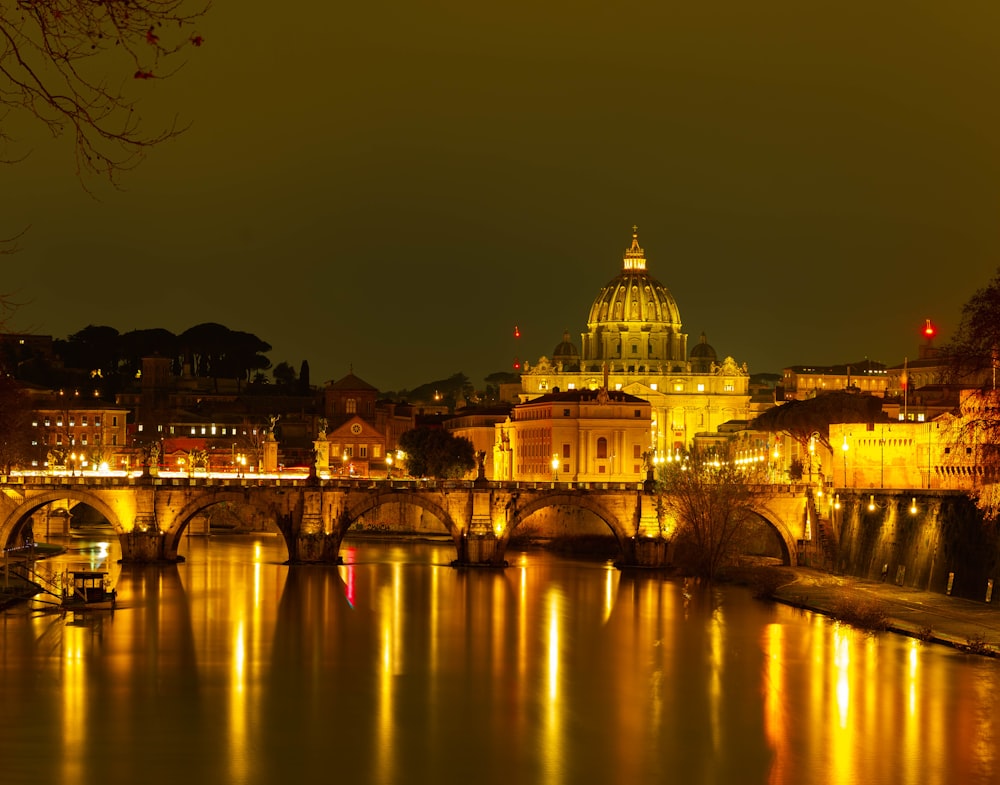 a bridge over a river with a building in the background