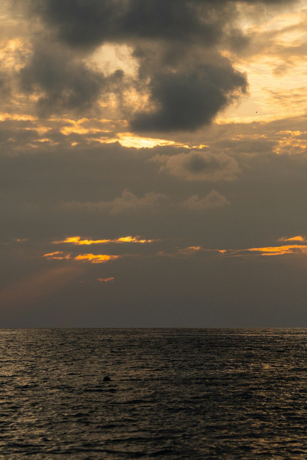 a large body of water under a cloudy sky