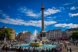 a crowd of people standing around a fountain