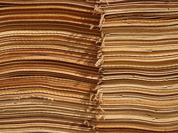 Stacked plywood sheets showing different wood grain patterns and finishes.