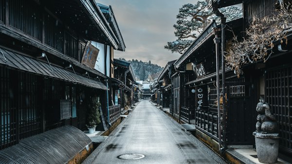 A long narrow street lined with wooden buildings — Takayama, Japan