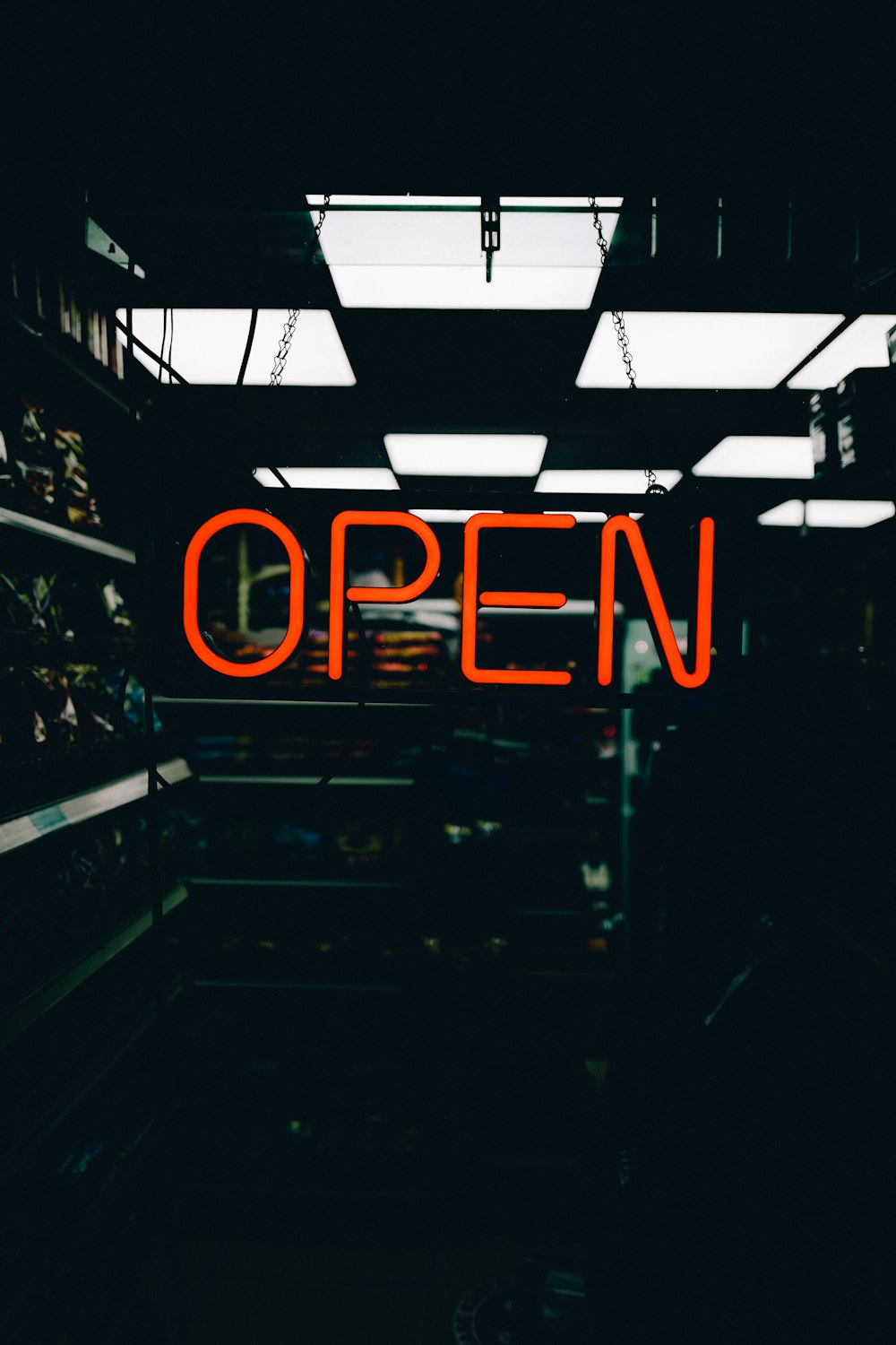 a neon sign that reads open in a dark room