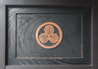 Close-up of a wooden plaque engraved with a delicate floral design.