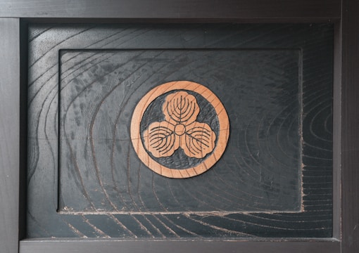 Close-up of an elegant wooden plaque with intricate floral engraving.