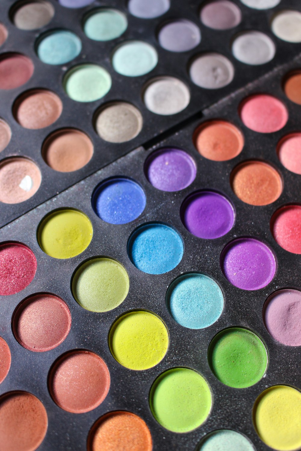 a close up of a colorful palette of eyeshades