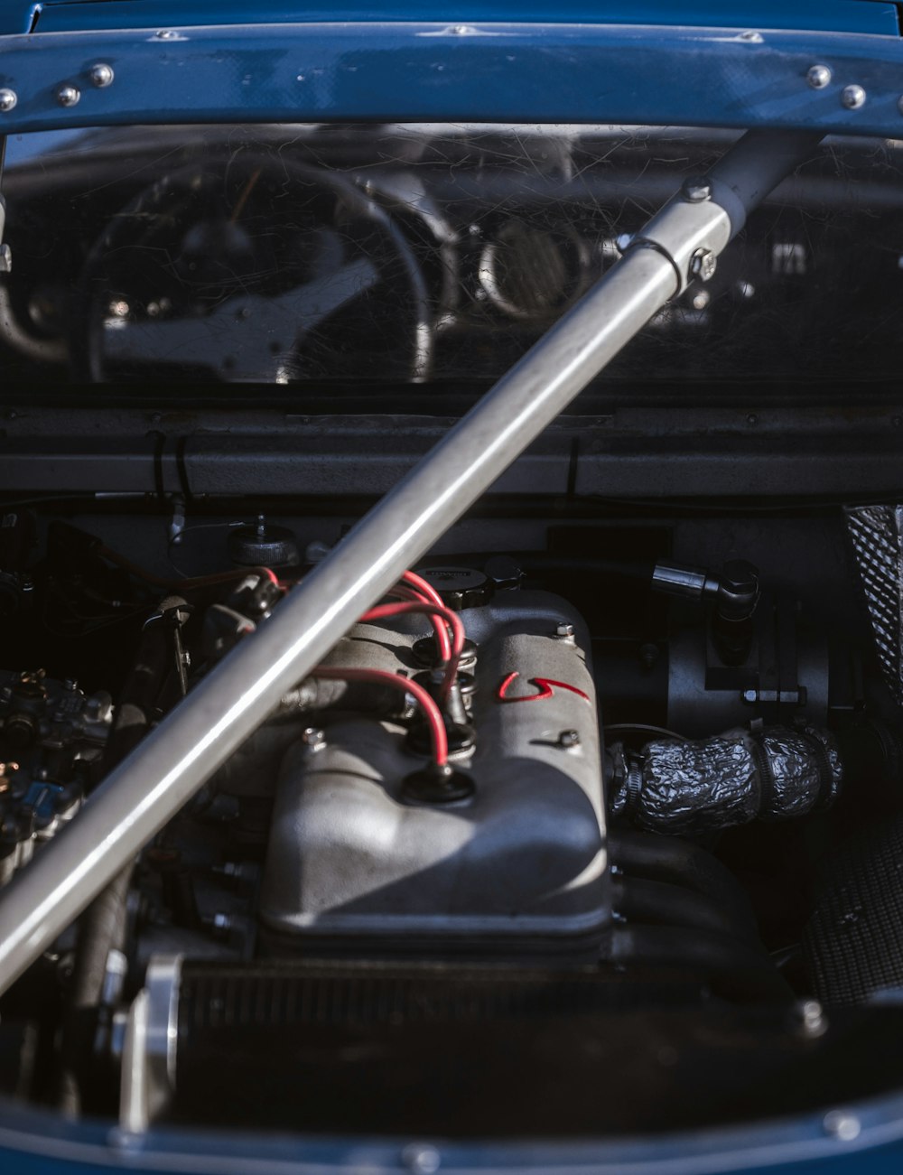 the engine compartment of a blue car with its hood open