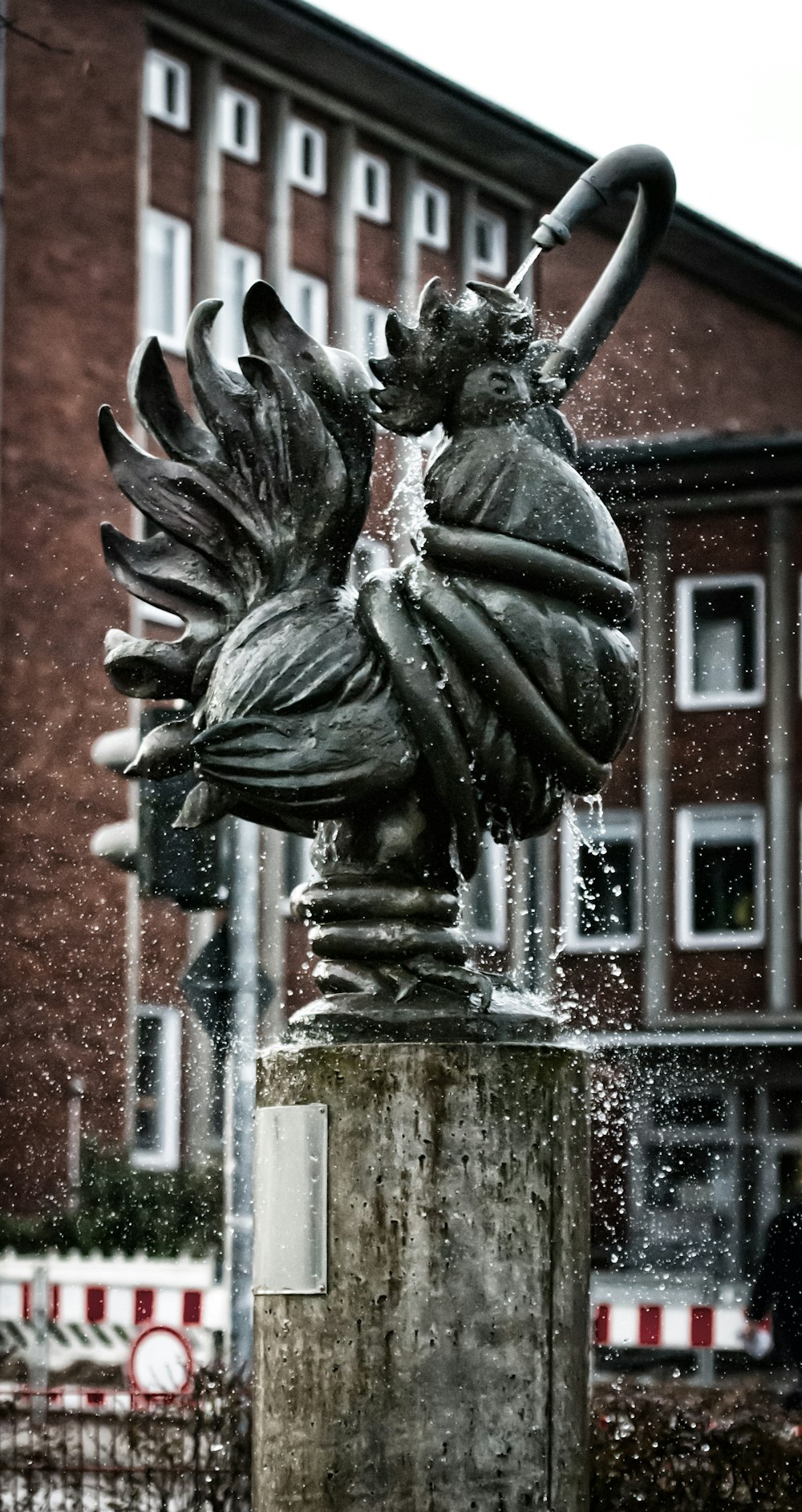 a statue of a flower is sprinkled with water