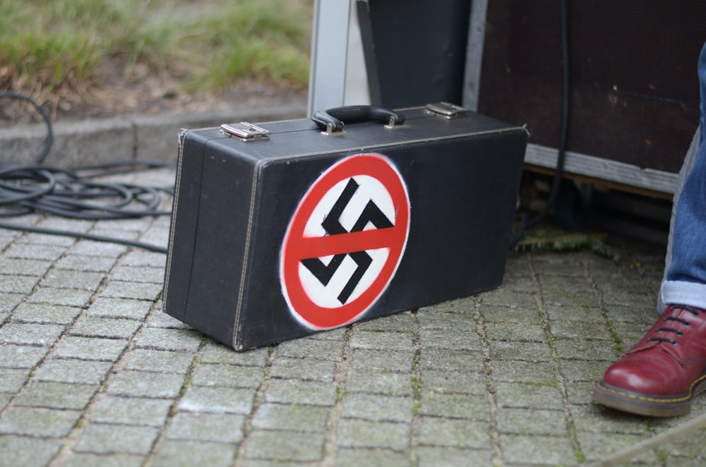 a suitcase sitting on the ground next to a person