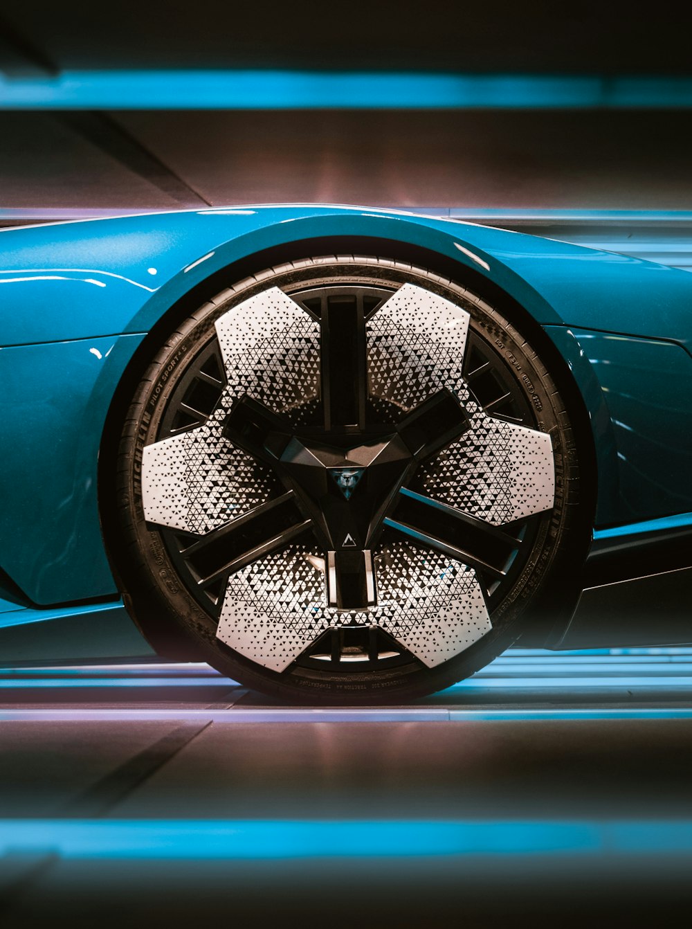 a close up of a blue sports car wheel