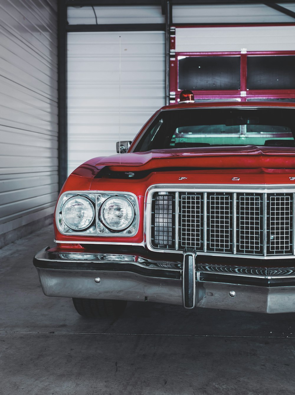 a red car is parked in a garage