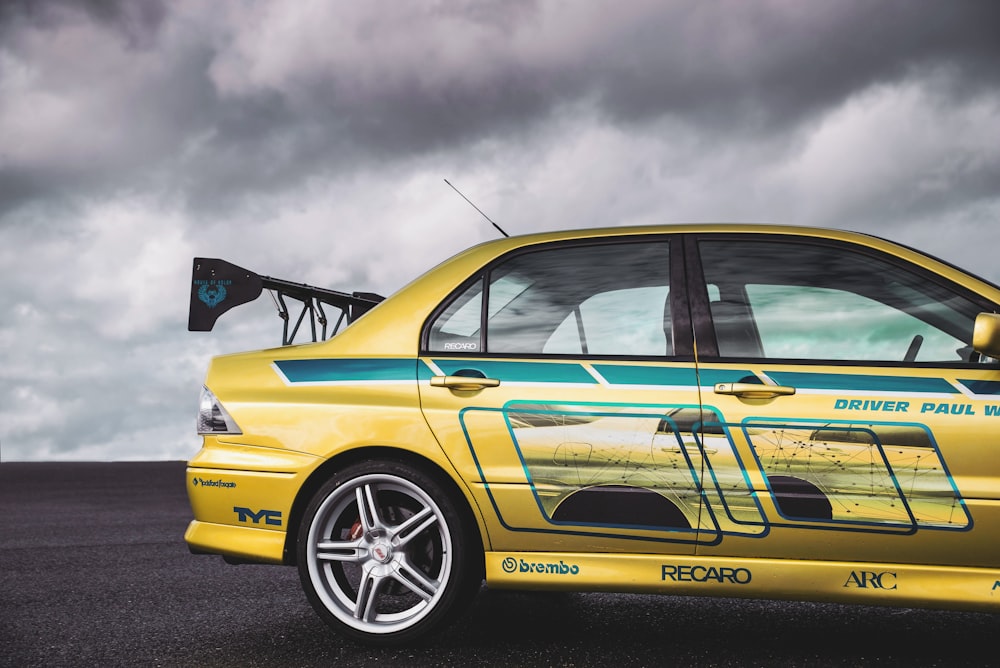 a yellow car parked on the side of a road