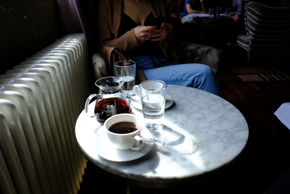 a person sitting at a table with a plate of food