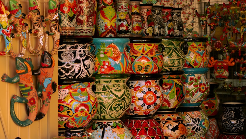 a wall full of colorful vases on display