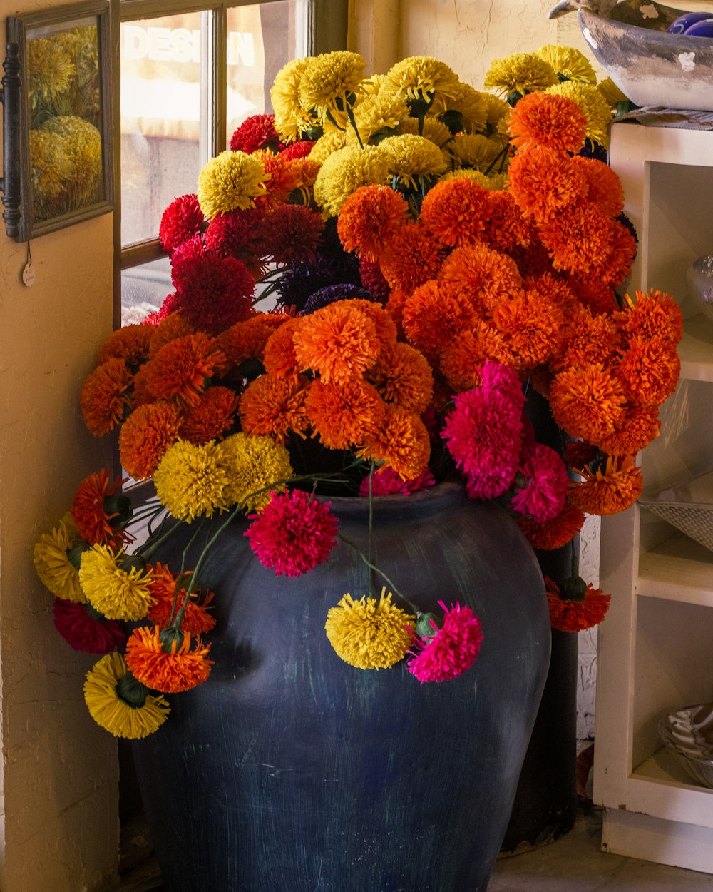 a large vase filled with lots of colorful flowers