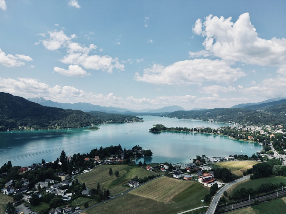 an aerial view of a lake surrounded by mountains