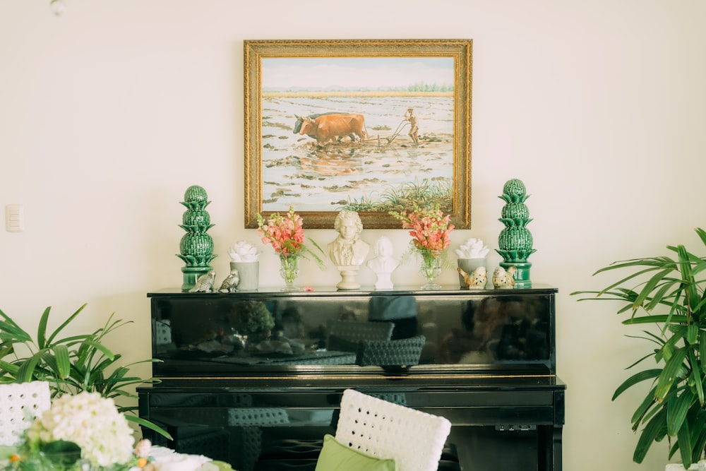 a living room with a piano and a painting on the wall