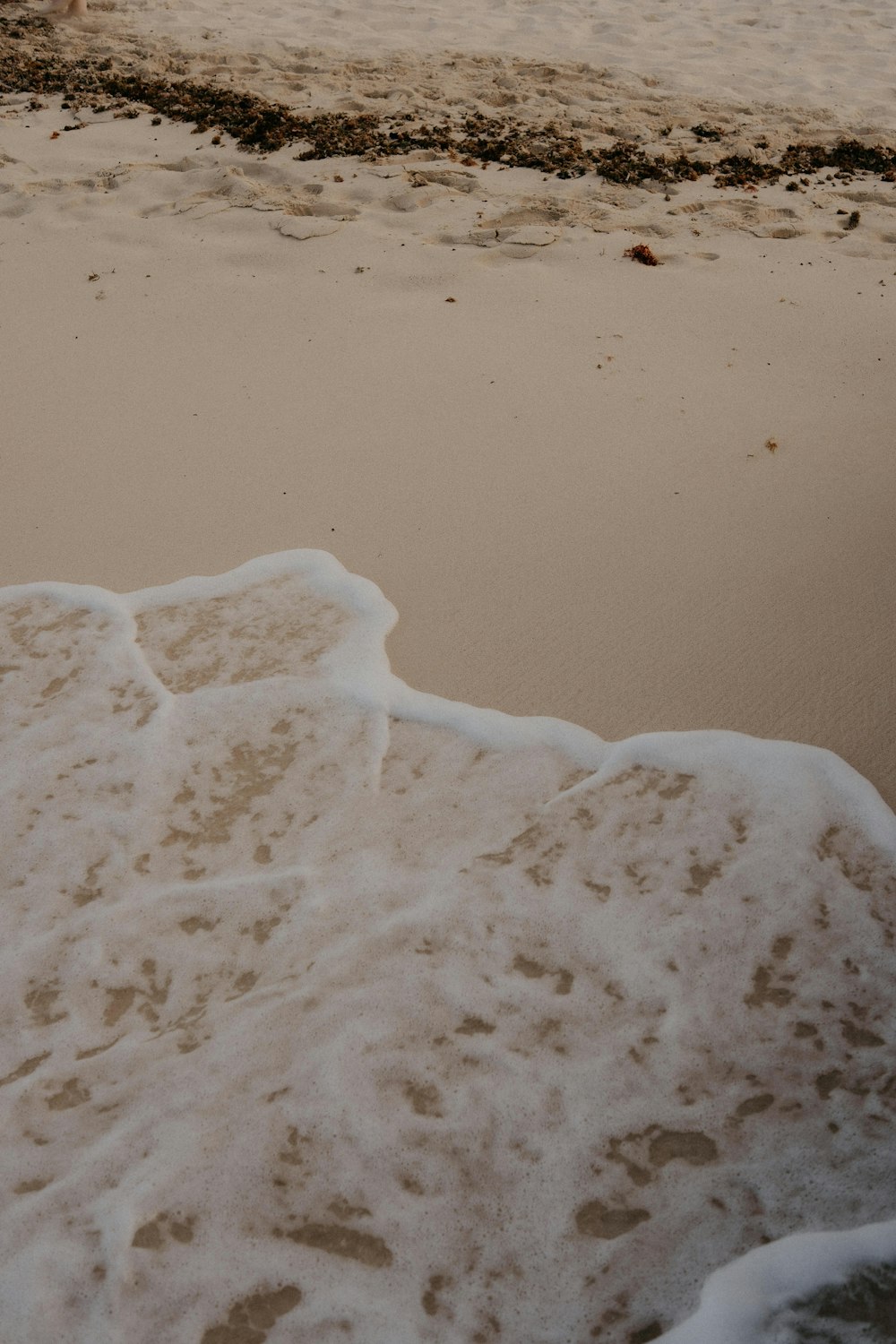 a surfboard sitting on top of a sandy beach