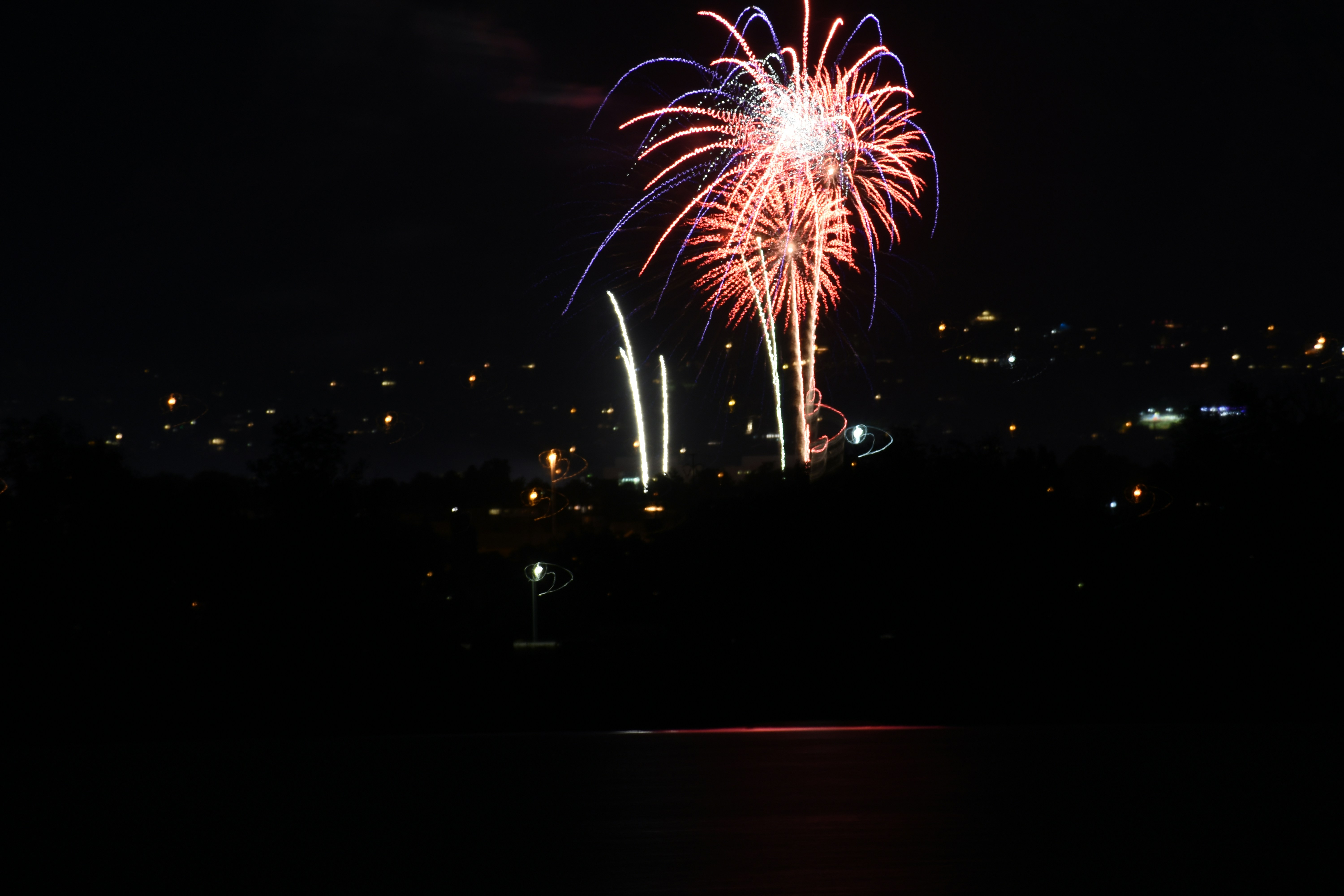 a fireworks display is lit up in the night sky