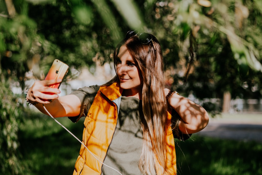 a woman is taking a picture with her cell phone