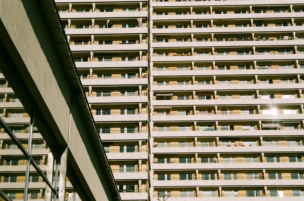 a tall building with balconies next to it