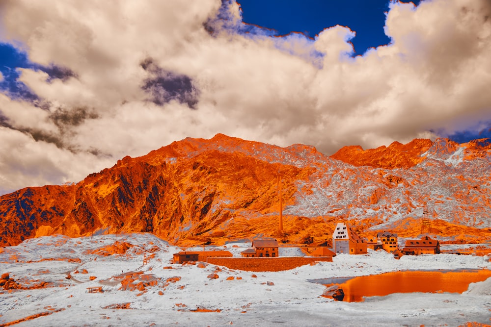 a snow covered landscape with a mountain in the background