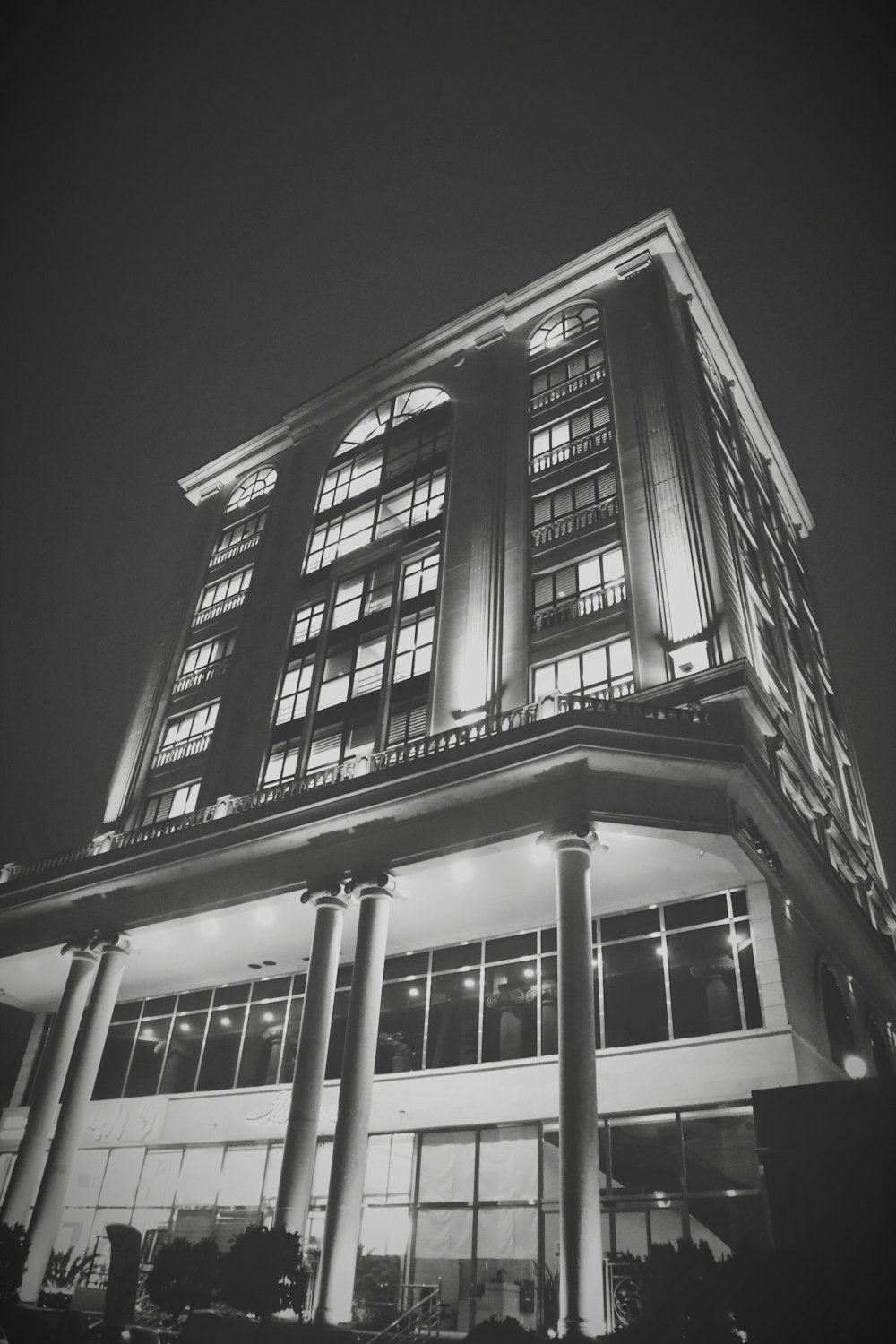 a tall building with many windows lit up at night