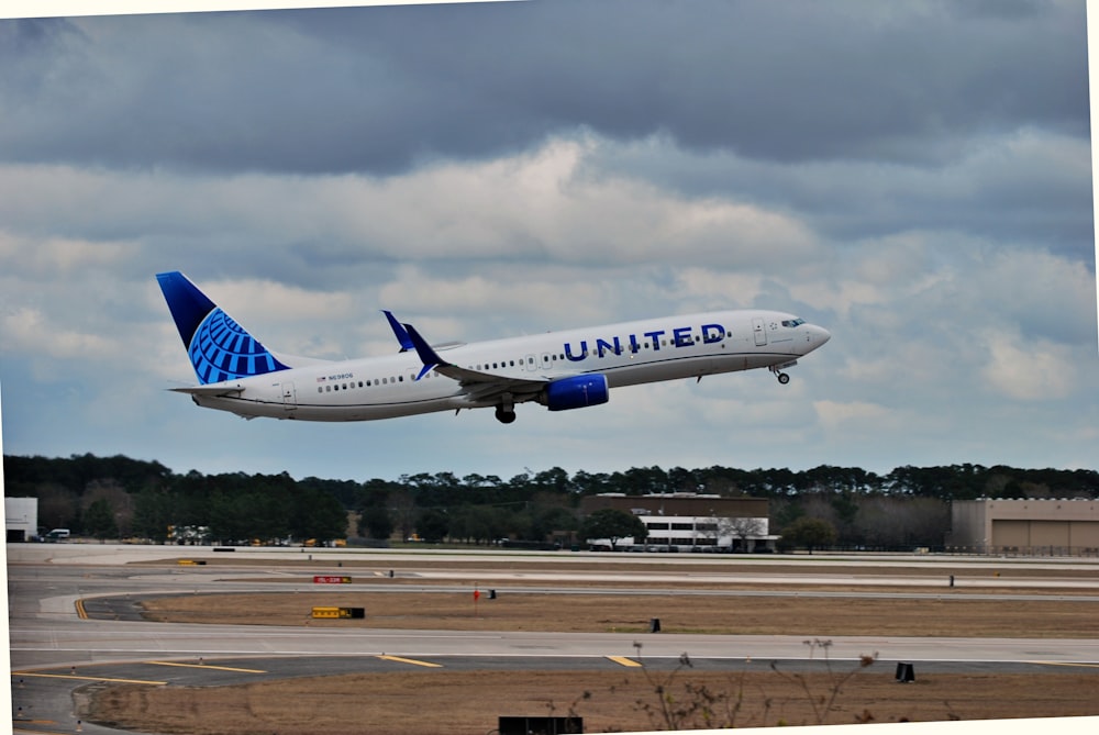 a large jetliner flying through a cloudy sky