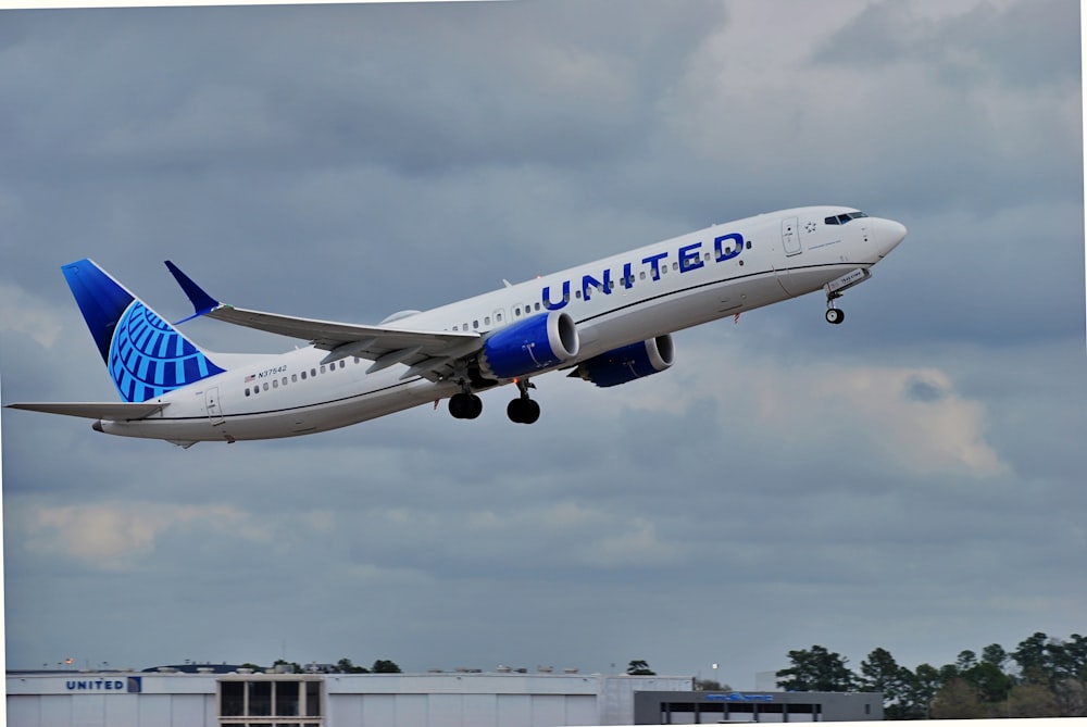 a large jetliner flying through a cloudy sky