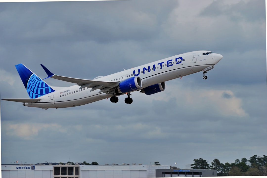 a large jetliner flying through a cloudy sky, United 737-9 Max out of IAH