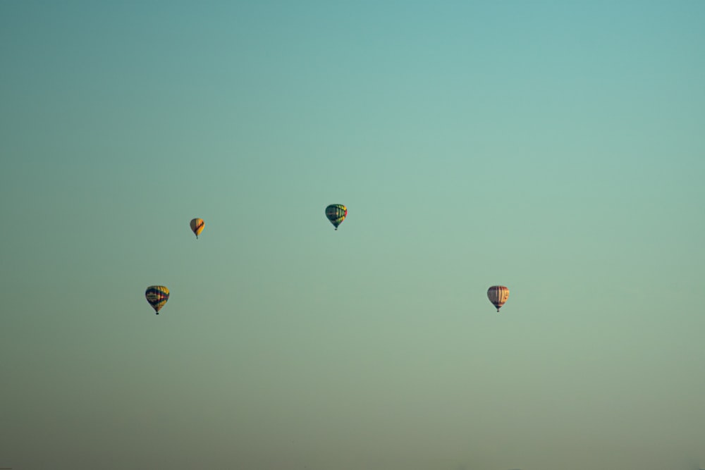 a group of hot air balloons flying in the sky