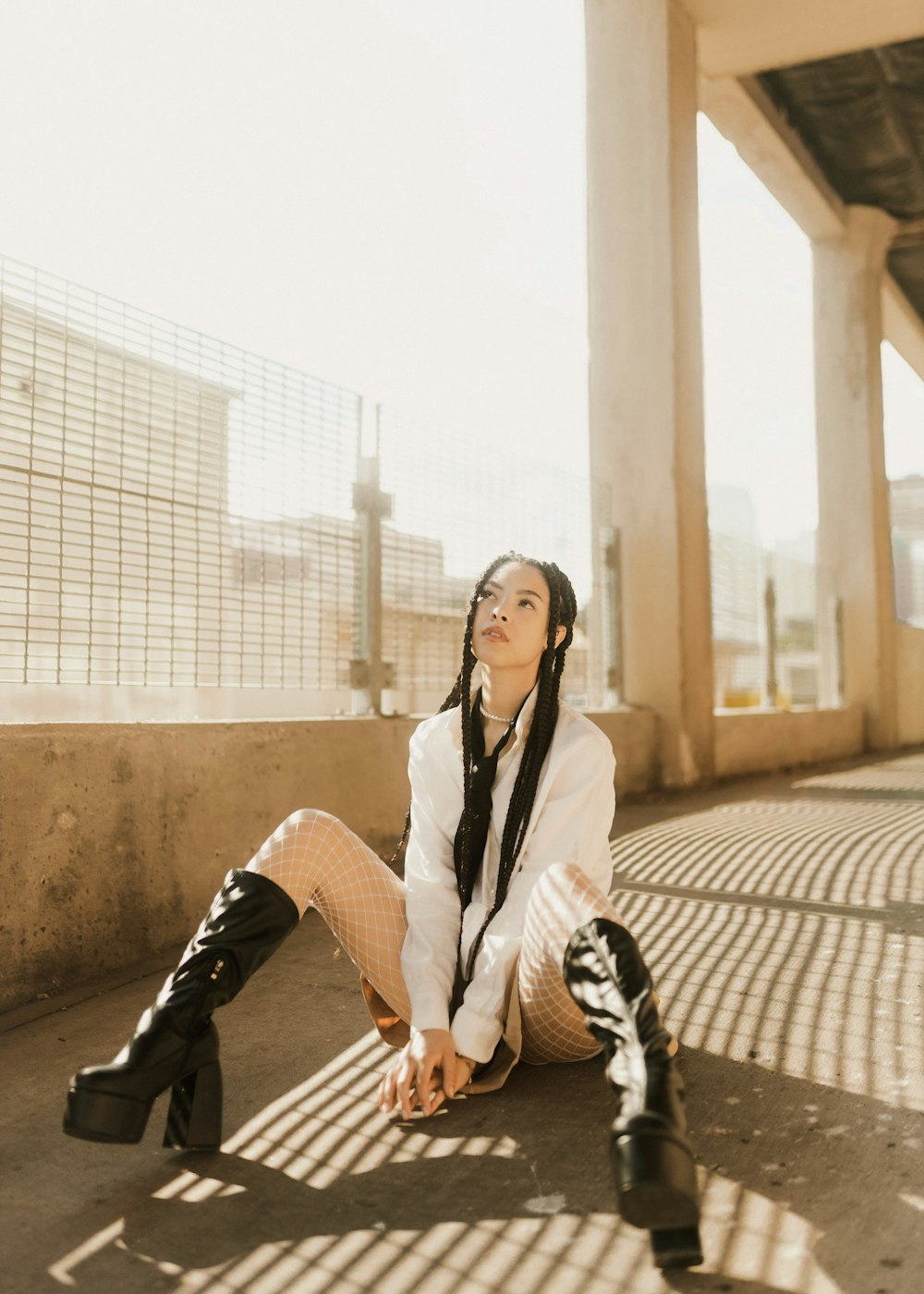 a woman sitting on the ground with her legs crossed