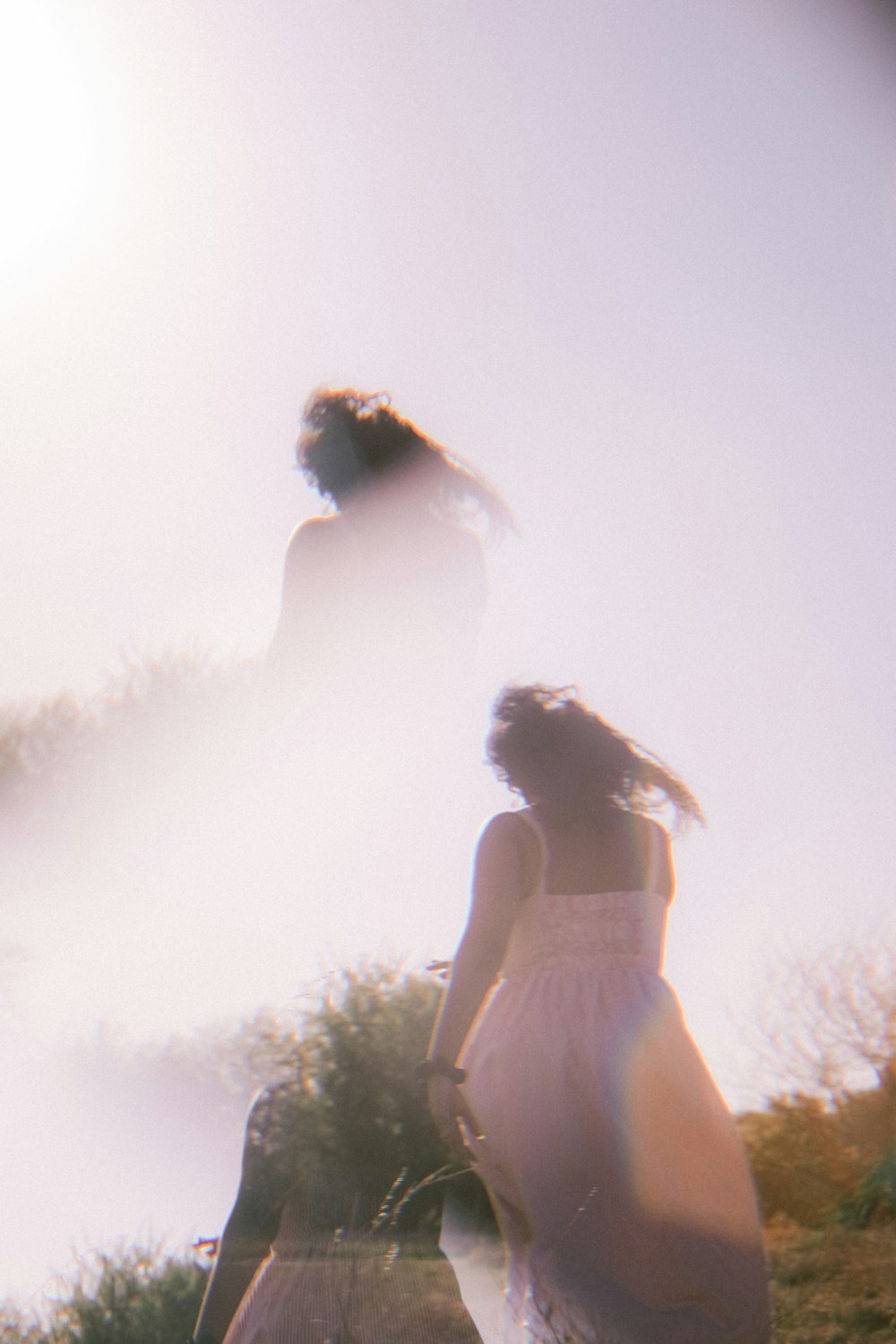 a blurry image of two women walking down a hill