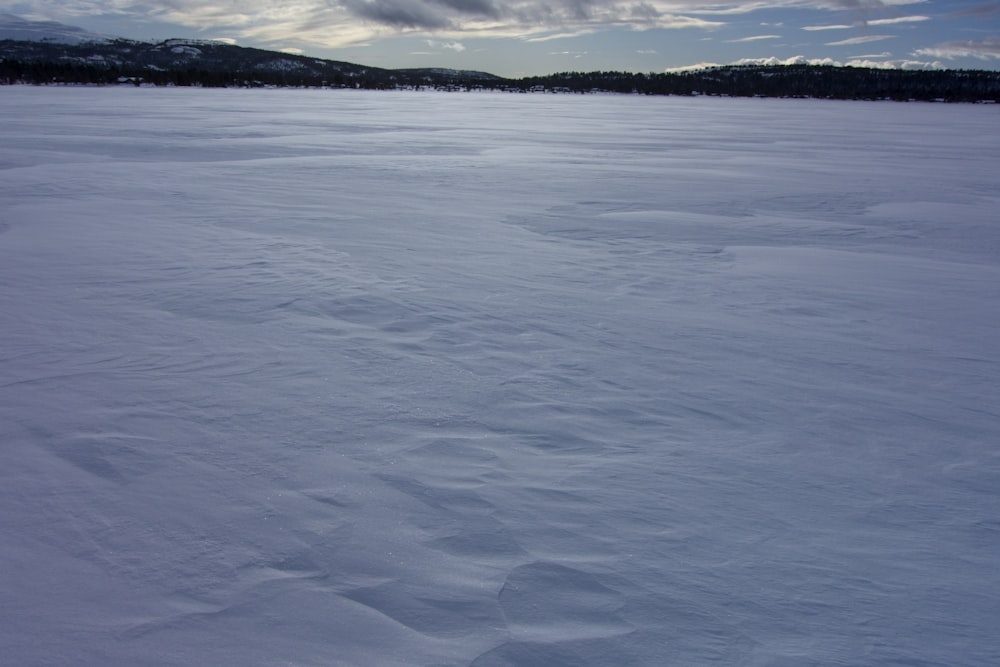 a person riding skis on top of a snow covered slope