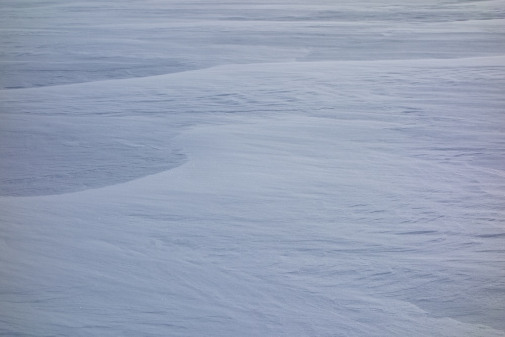 a man riding skis down a snow covered slope