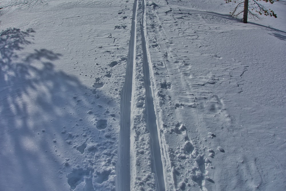 a person riding a snowboard down a snow covered slope