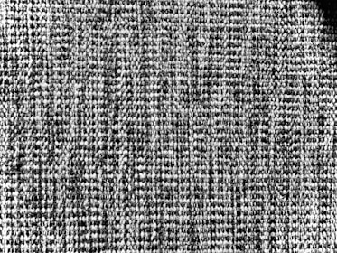 Close-up of black and white textured fabric, evoking timeless fashion and heritage.