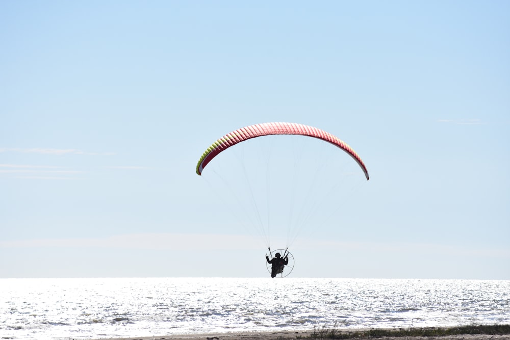 a person is parasailing in the ocean on a sunny day