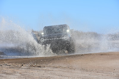 a truck driving through a large puddle of water