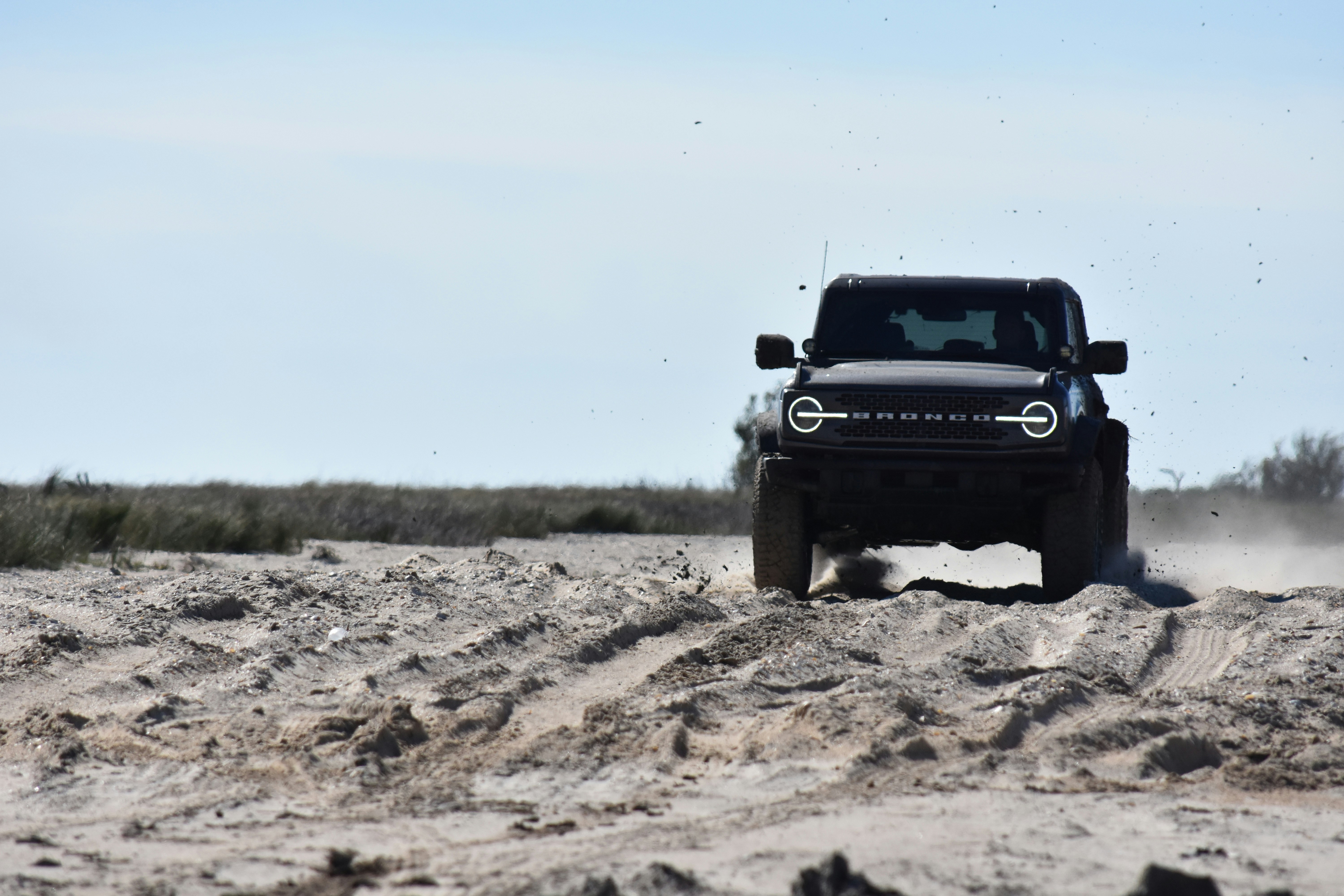 Une jeep roulant dans le sable par une journée ensoleillée