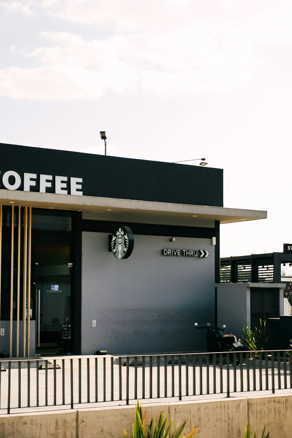 a black and white building with a starbucks sign