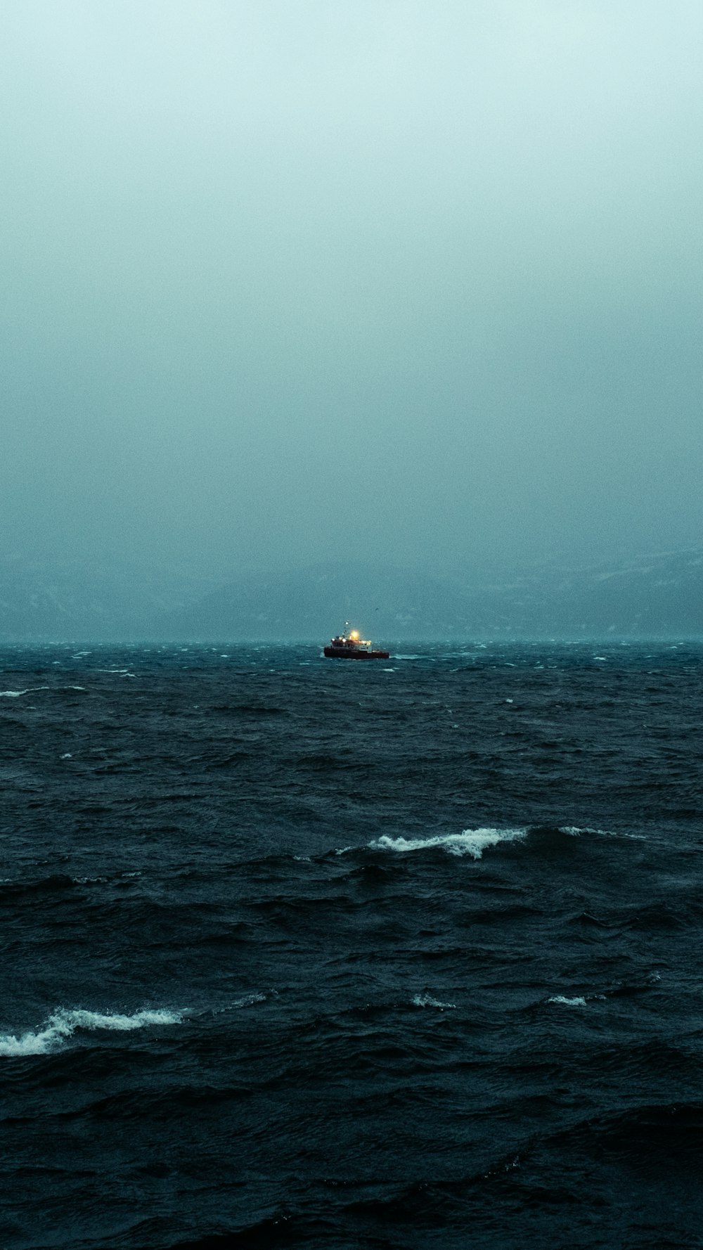 a boat in the middle of a large body of water