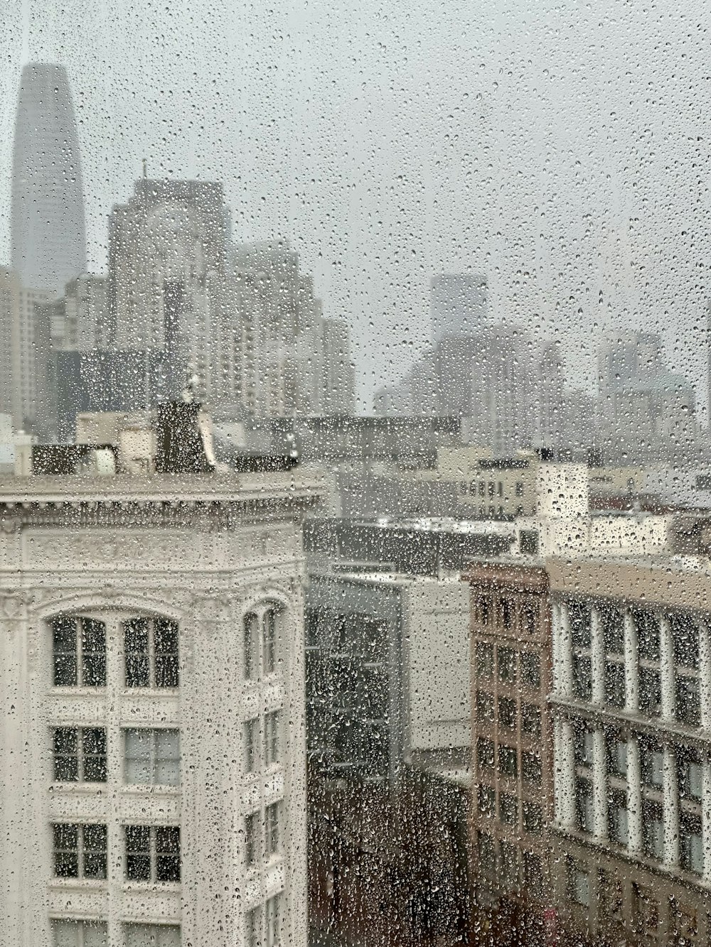 a view of a city through a rainy window